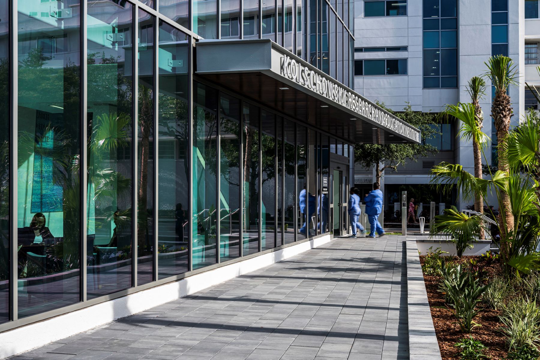 people walking through the entry door to a research and education building in sarasota, florida