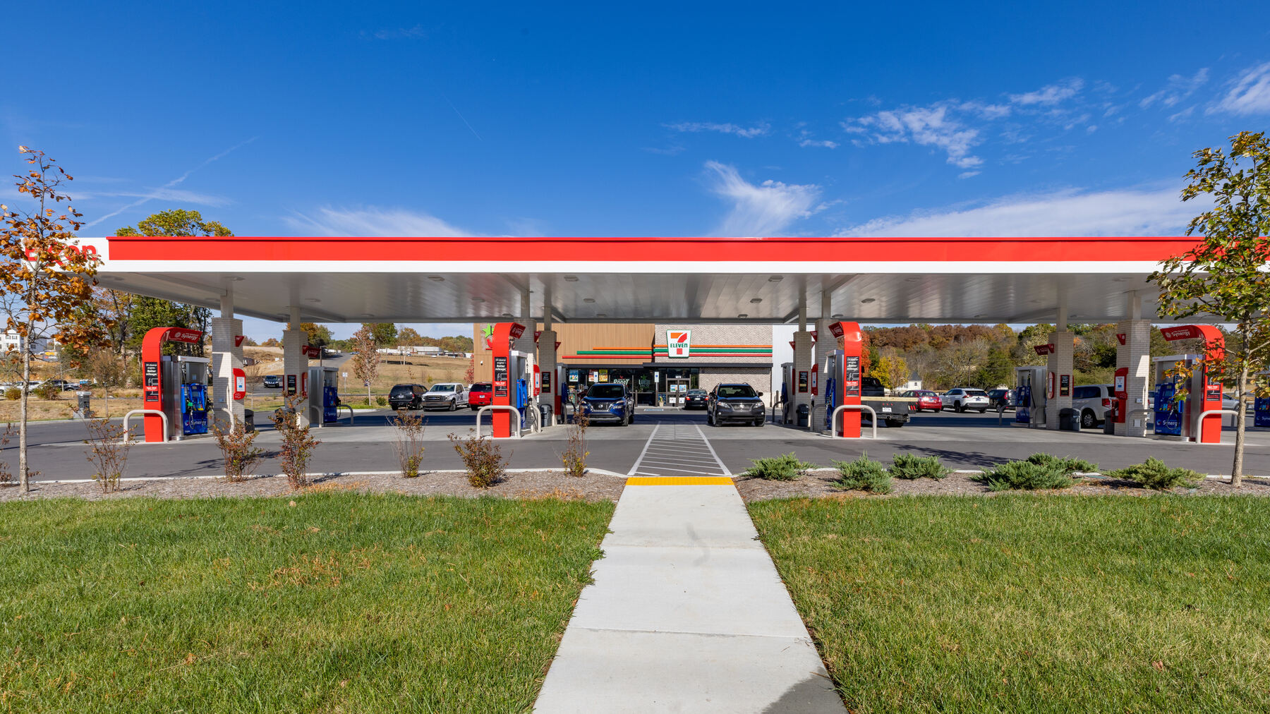 A 7-Eleven gas station with grass and landscape in front
