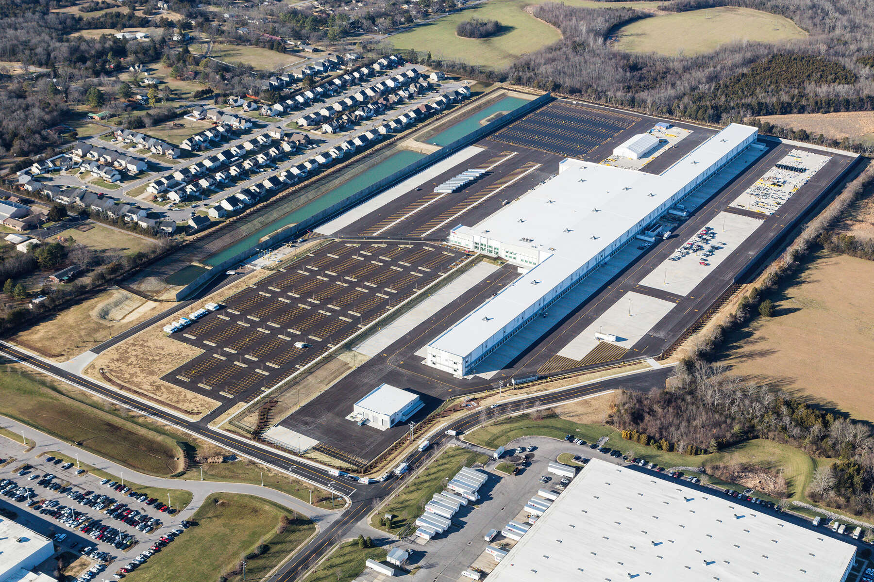 A drone shot of an industrial plant surrounded by fields