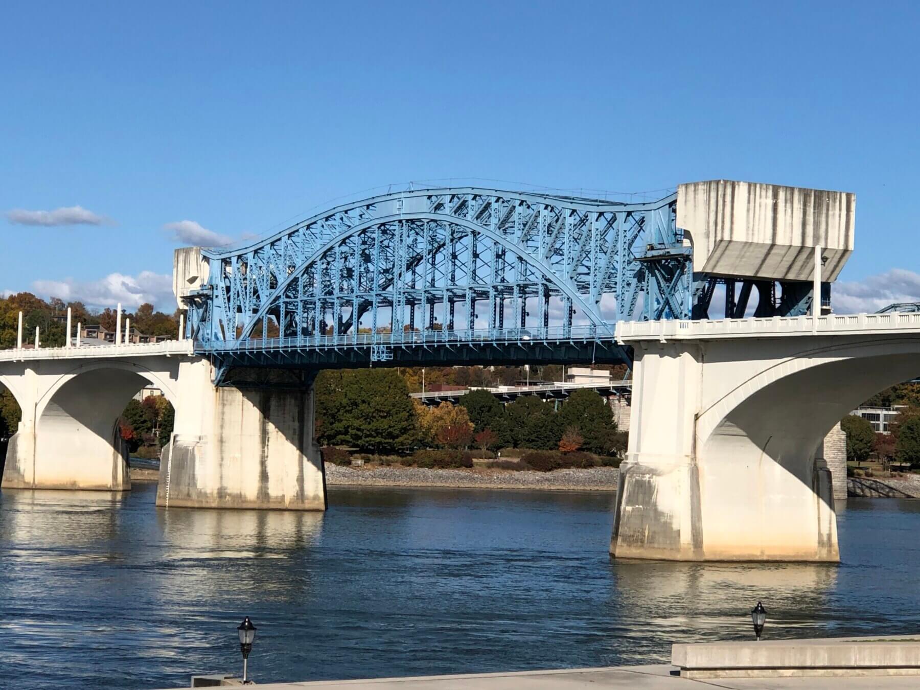 The Market Street Bridge over water with trees and a blue sky