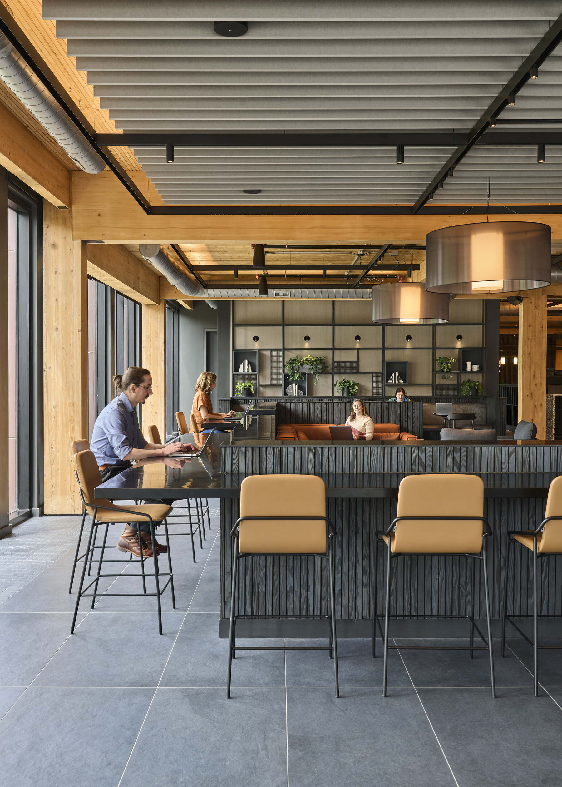 people working at a bar top in a lounge in an office