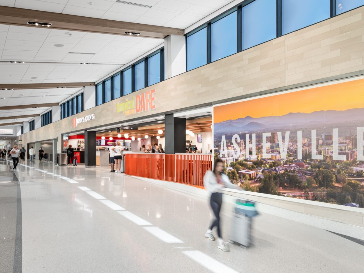 A person walking in Asheville Regional Airport's expanded terminal