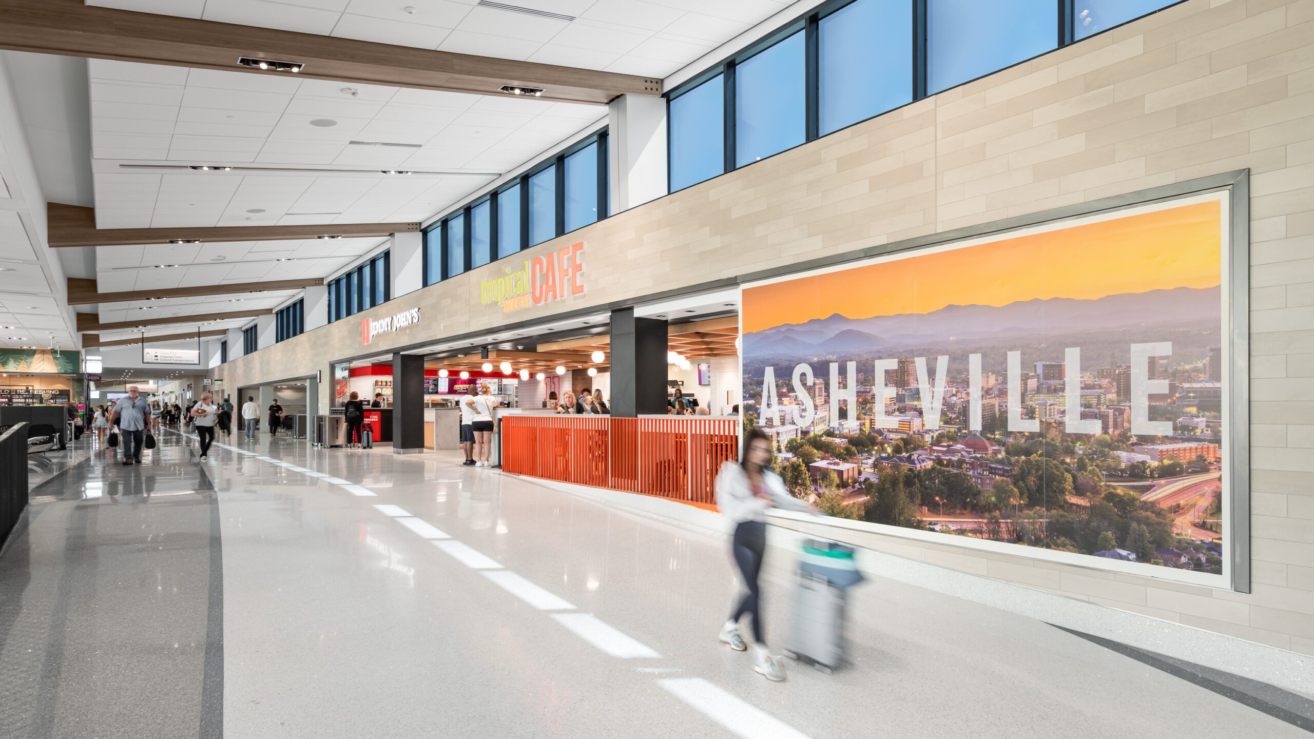 A person walking in Asheville Regional Airport's expanded terminal