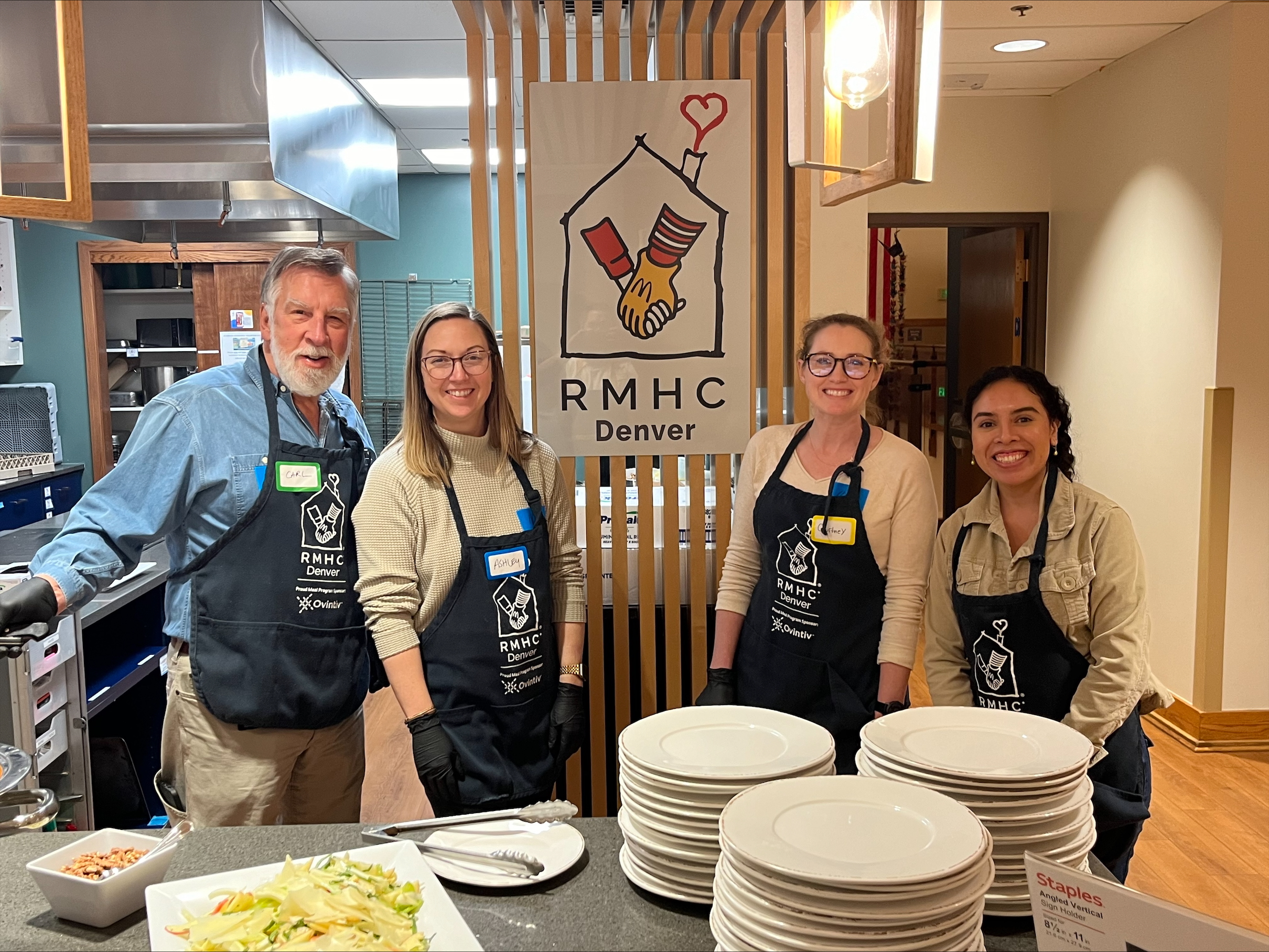 four people serving dinner at Ronald McDonald House in Denver, Colorado