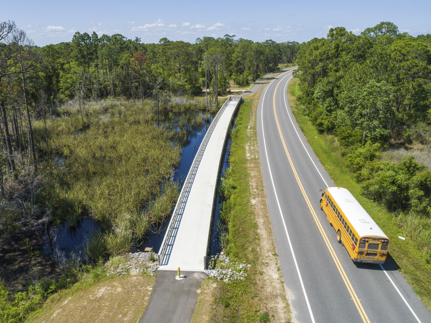 Aerial image of a pedestrian bridge alongside roadway in Florida.